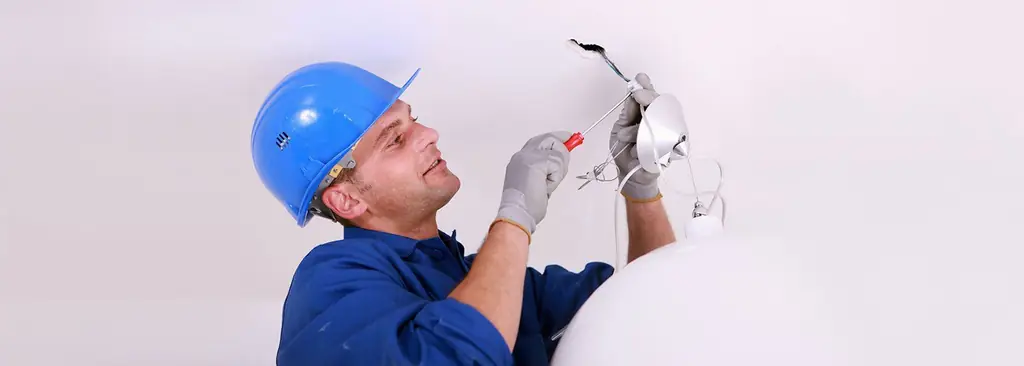 Electrician on a ceiling fixture install